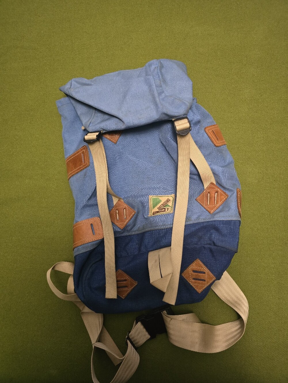 Vintage Outbound blue nylon backpack with tan leather details and a distinctive